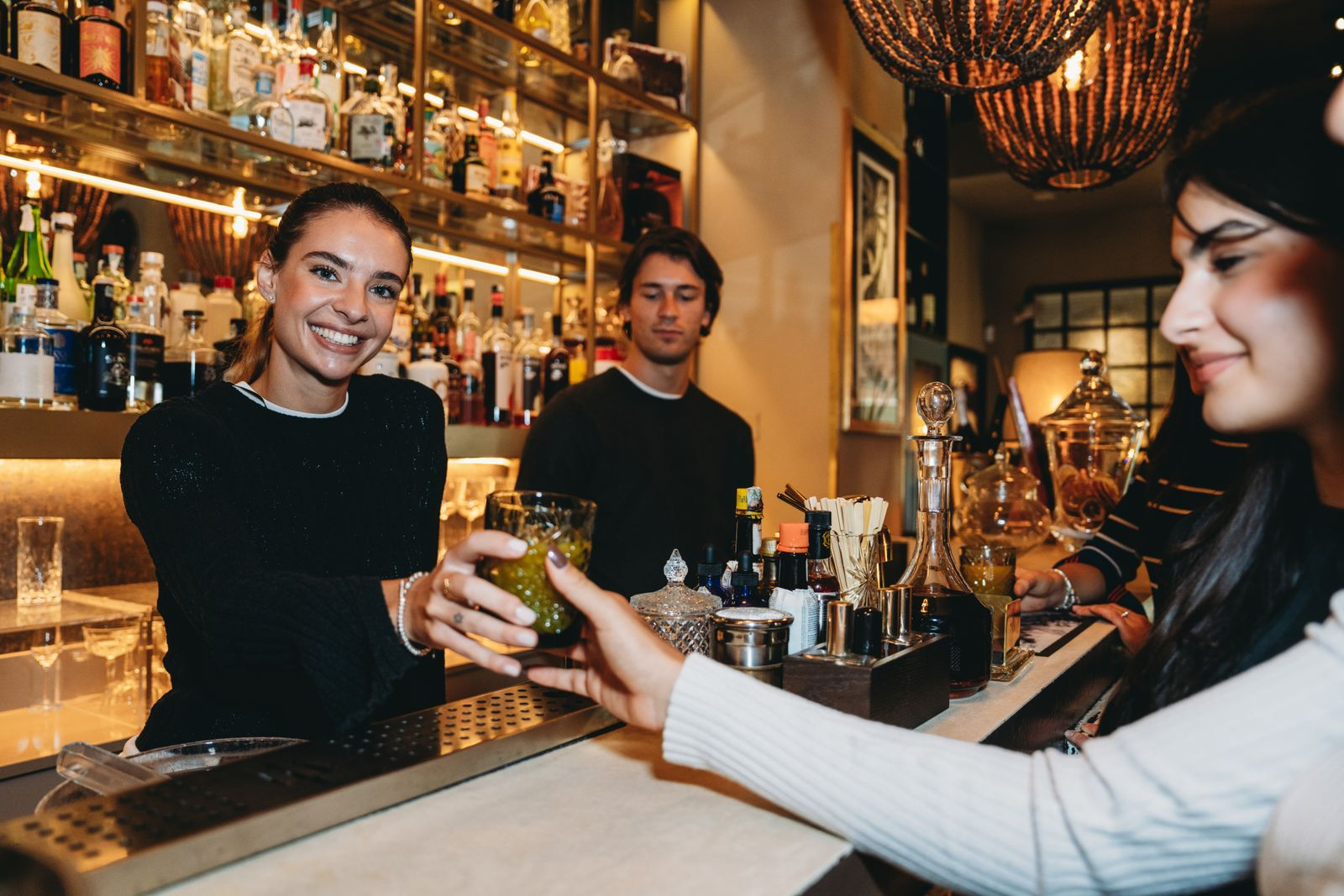 Hospitality staff serving drinks in a bar